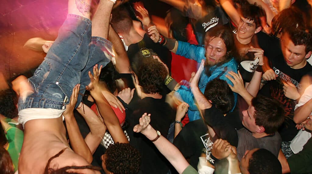 Crowdsurfing over a mosh pit. CCby20 | Wikipedia